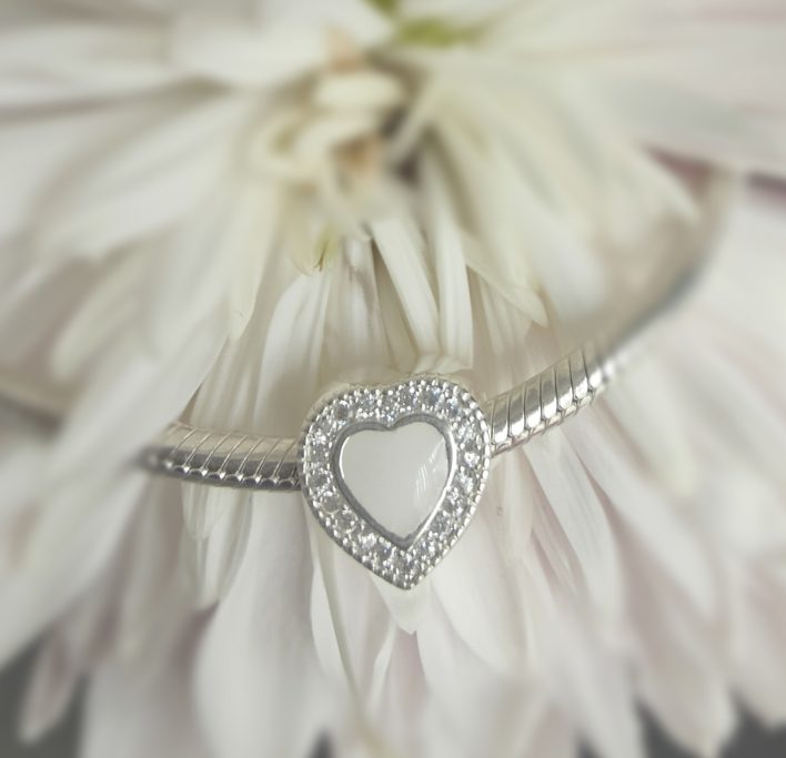 Sterling Silver heart charm with cubic zirconia around the outer edge and a breastmilk centre